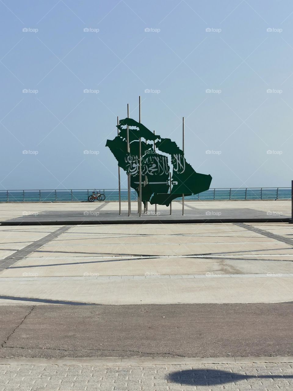 The flag of the Kingdom of Saudi Arabia, It is a green flag featuring in white an Arabic inscription and a sword. The inscription is the Islamic creed, or shahada: "There is no god but God; Muhammad is the Messenger of God".