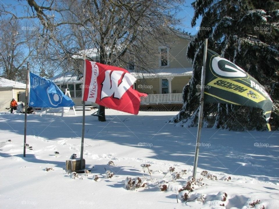 Wisconsin sports flags blowing in the wind.