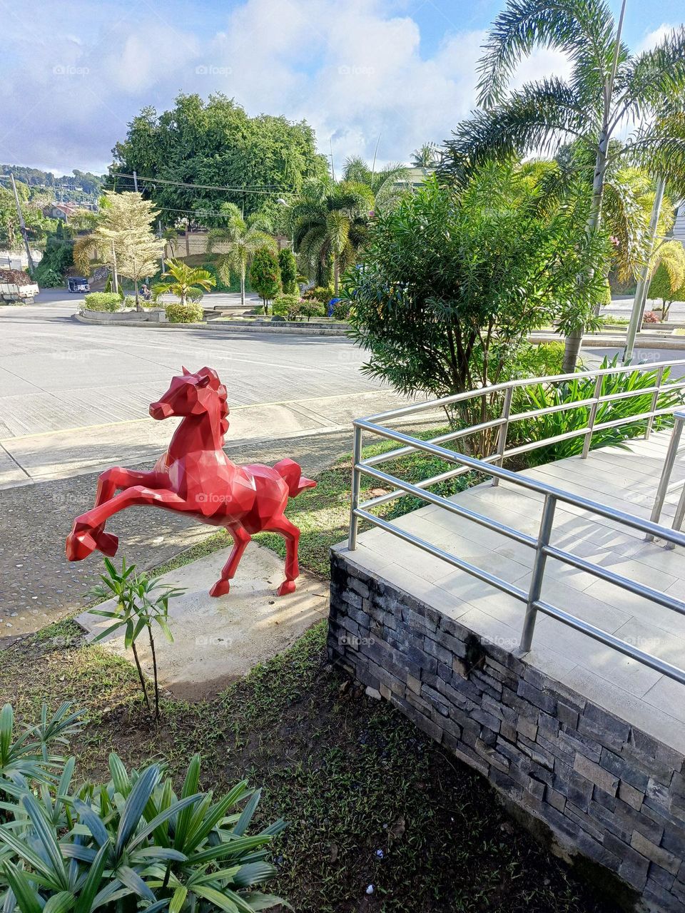 "Bold and vibrant, the red horse leaps into a serene green world, blending energy with tranquility."