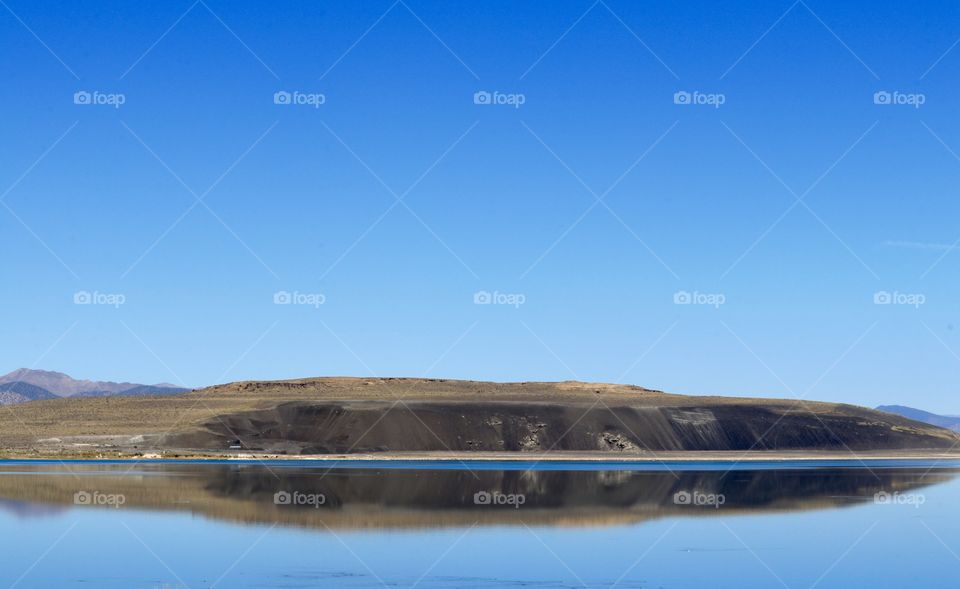 Reflection of high Sierra mountain on lake suitable as background, wallpaper, desktop, plenty of negative space for copy or text or desktop icons 