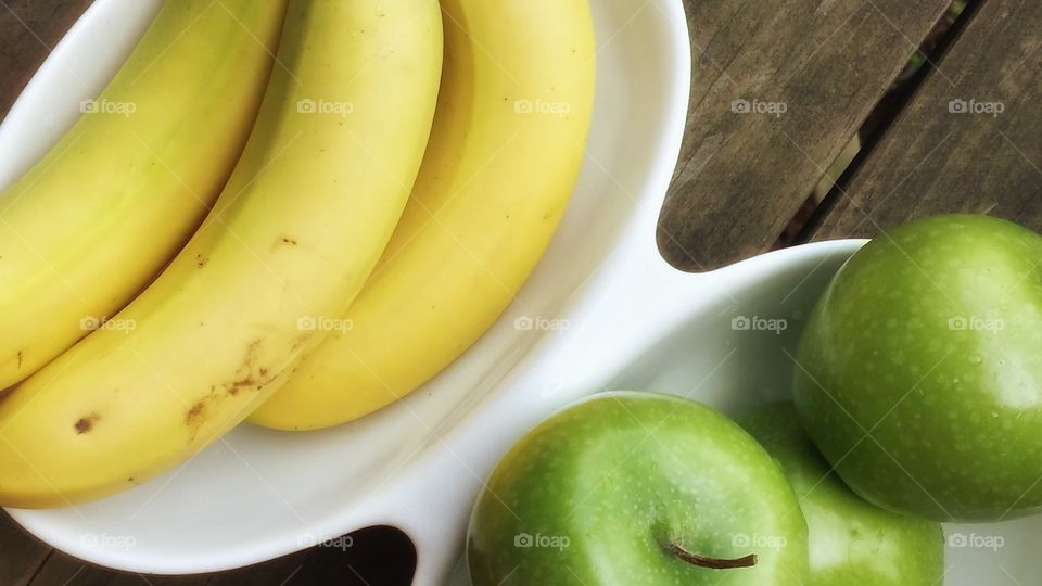 Food. Green Apples and Yellow Bananas