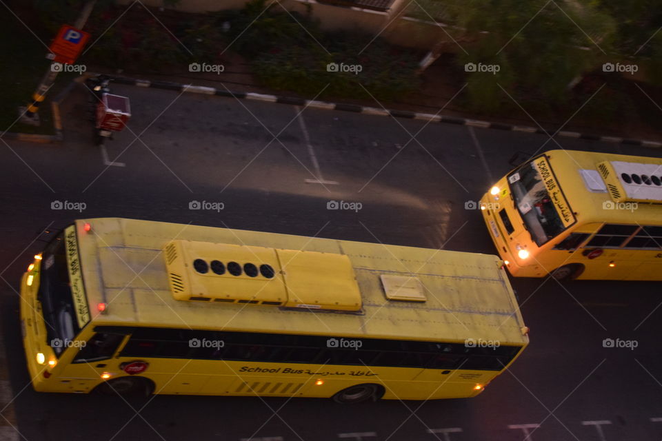 two school bus passing on the road