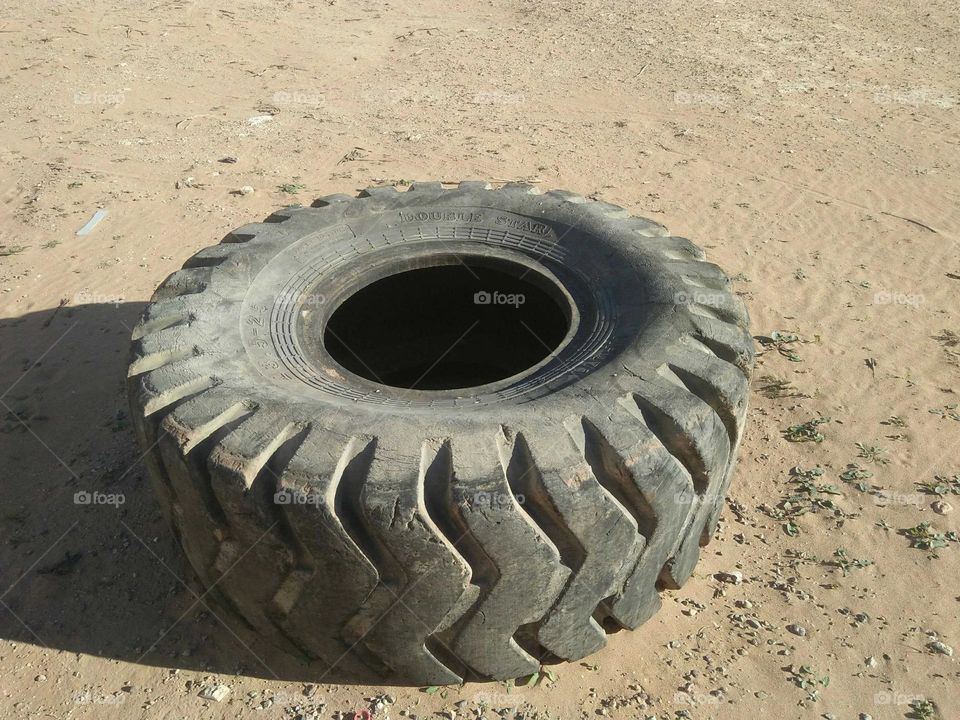 Alone wheel on sand.