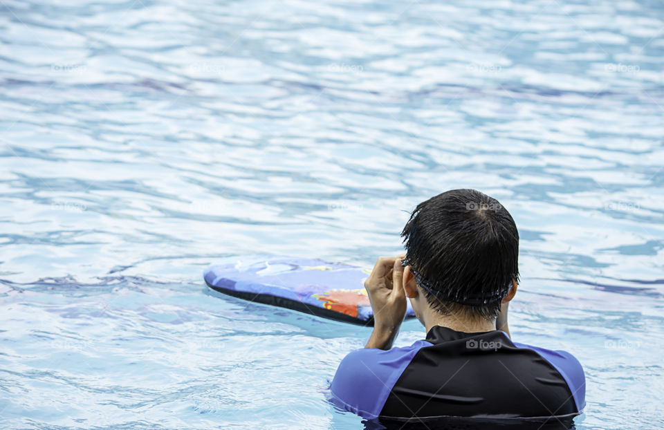 Asean boys are swimming in the pool.