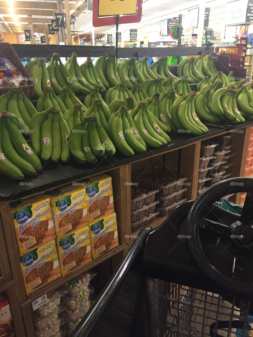 Grocery store with green bananas on display 