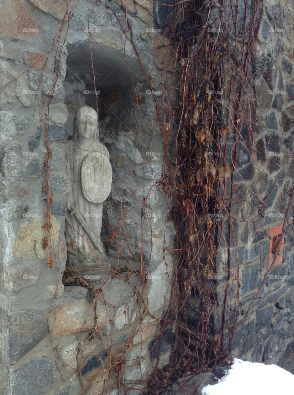 A statue of an angel in the wall of a castle