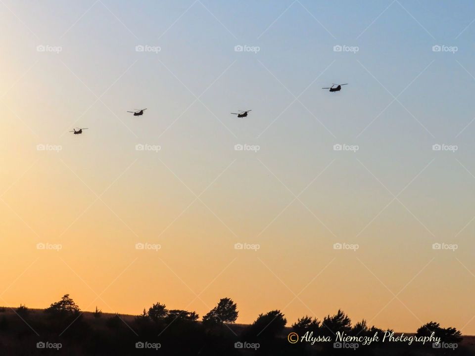 Helicopters ride into the sunset.  Can not make up these colors!