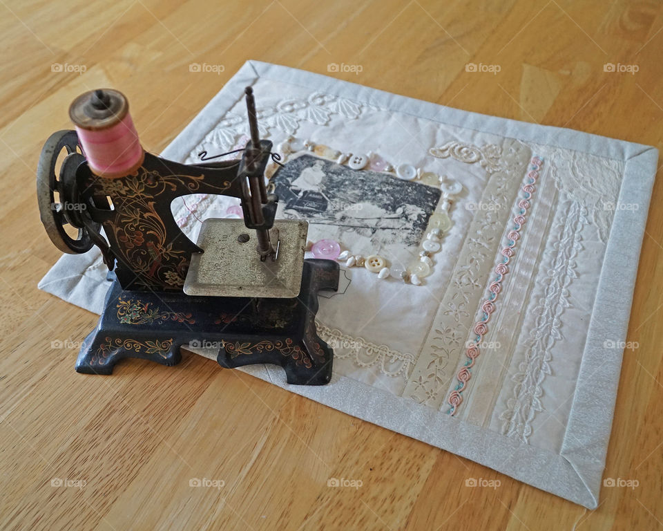 Antique children’s sewing machine with photo quilt