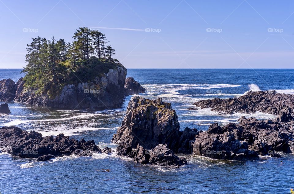 Rugged rock islands emerge from the ocean near the Wild Pacific Trail in Ucluelet, British Columbia, Canada 