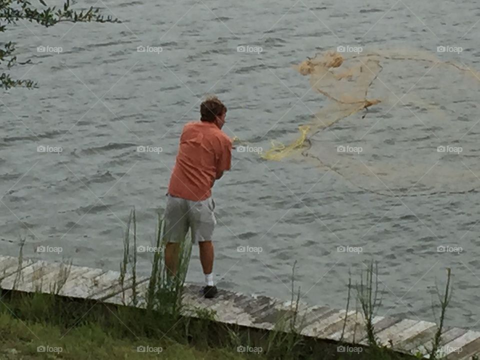 Man throwing a casting net