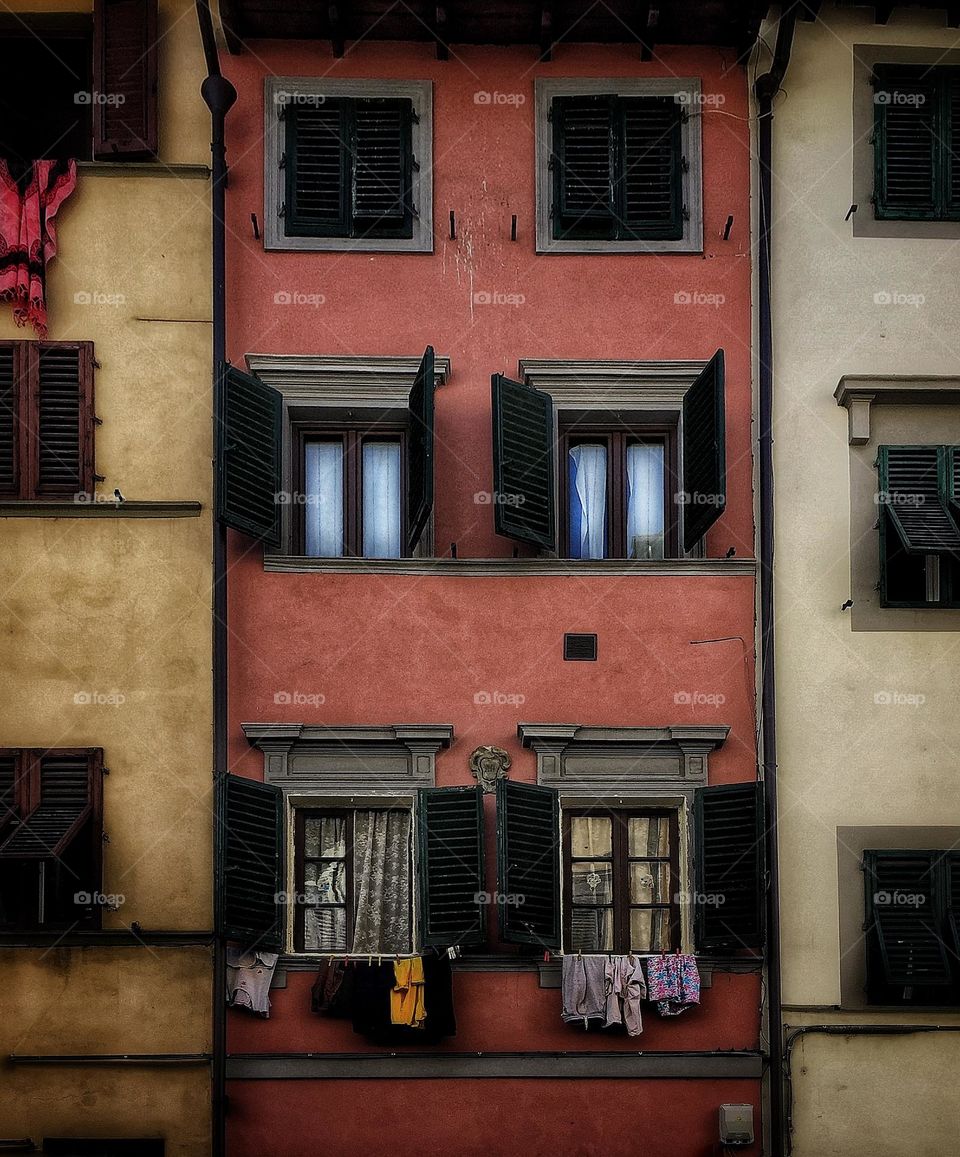 Lighted windows at nightfall in an old building in Rome, Italy 