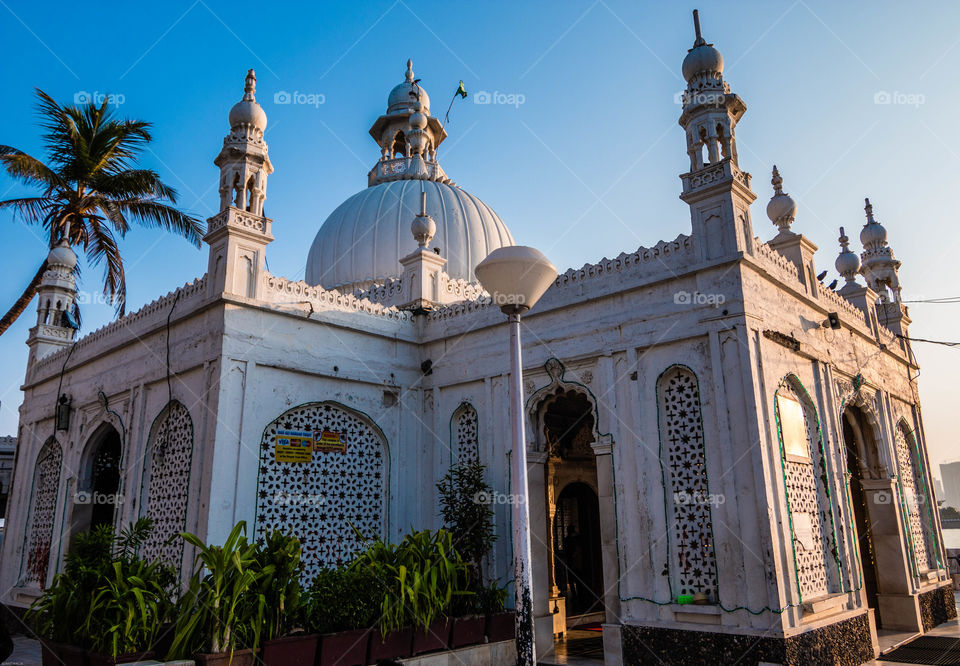 The Haji Ali Dargah is a mosque and dargah (tomb) or the monument of Pir Haji Ali Shah Bukhari located on an islet off the coast of Worli in the southern part of Mumbai.- wiki
