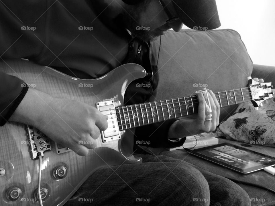 Human hand playing guitar