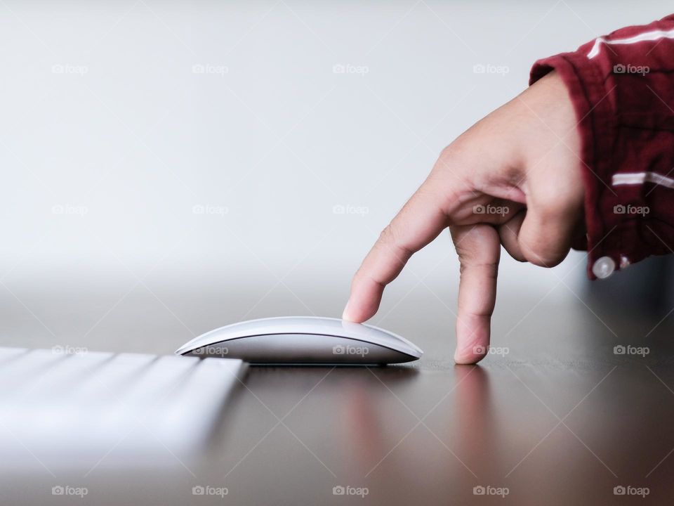 Hand approaching an apple mouse