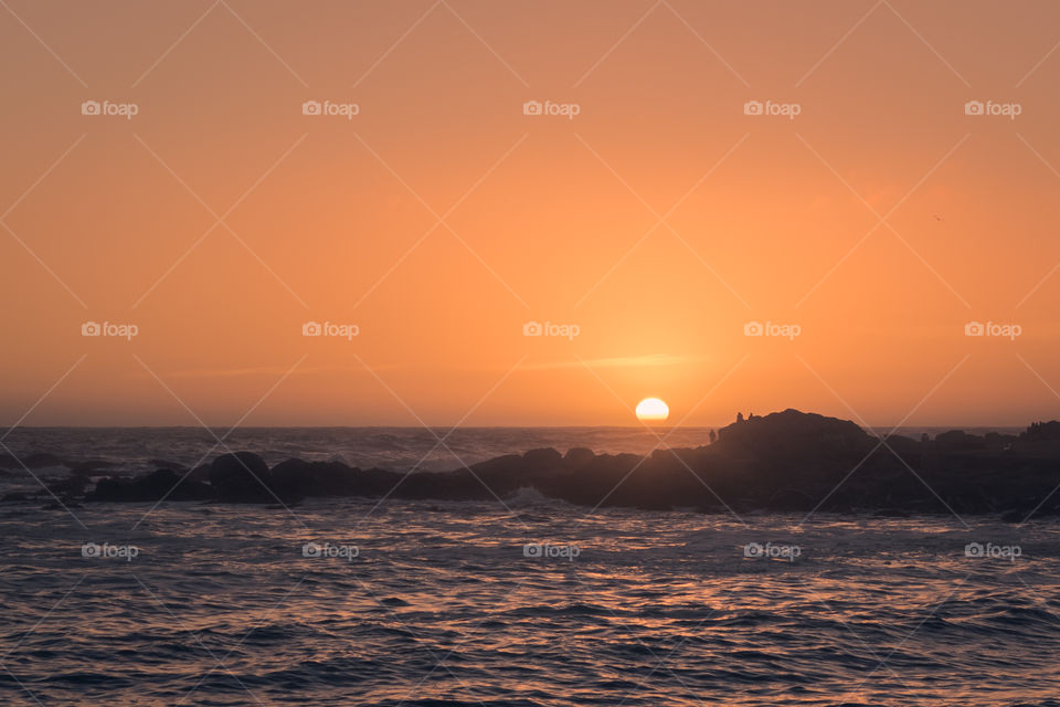 Beautiful and amazing orange sunset at the beach 