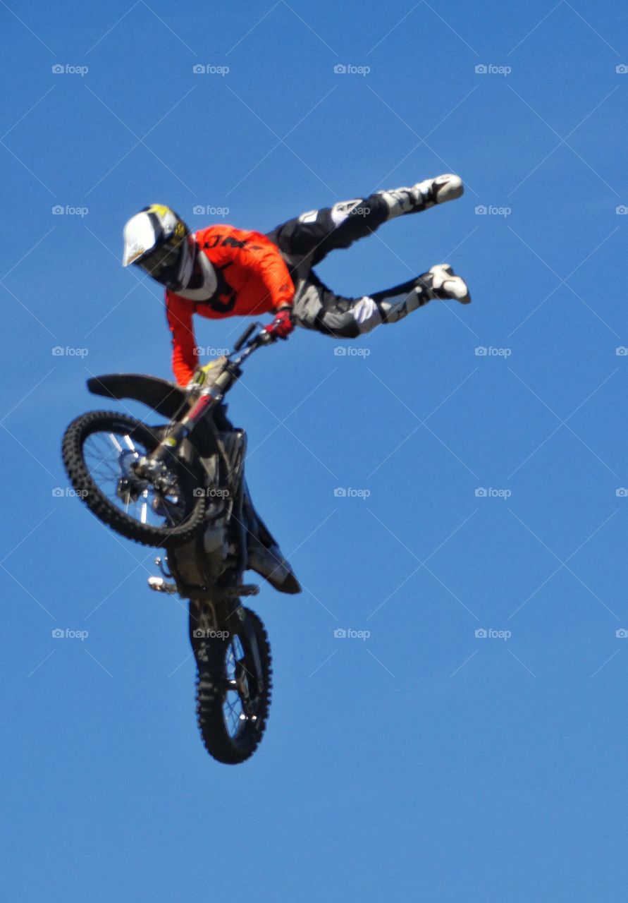 Crazy Motorcycle Stunt. Amazing Stunt Rider Performing Aerial Handstand On Motorcycle Handlebars
