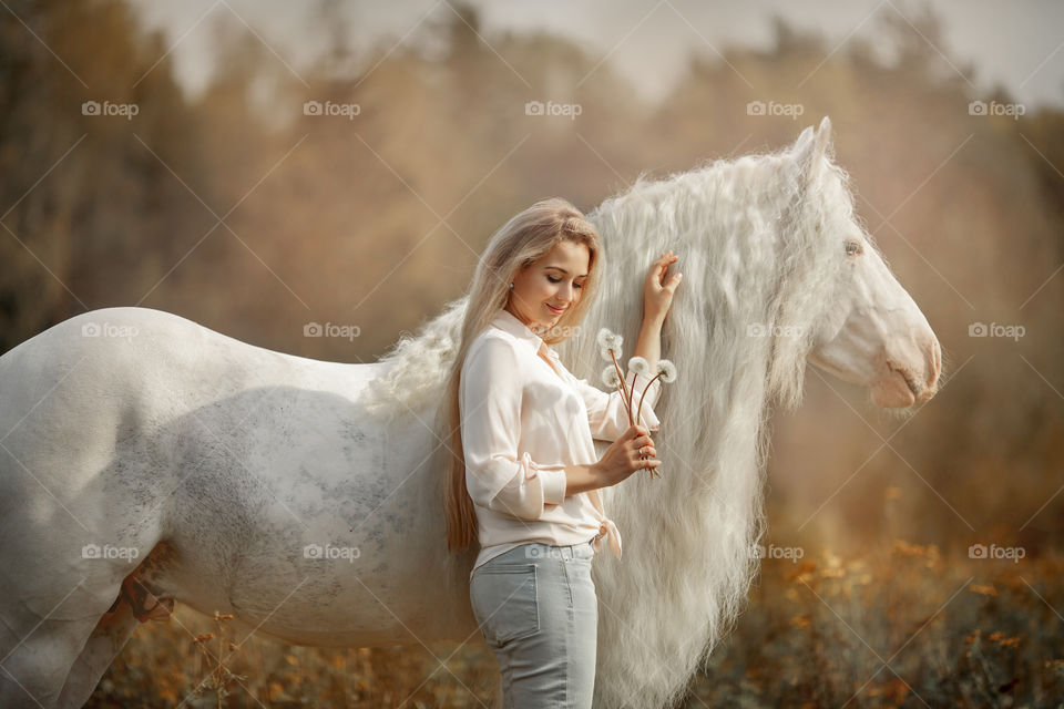 Beautiful young woman with horse