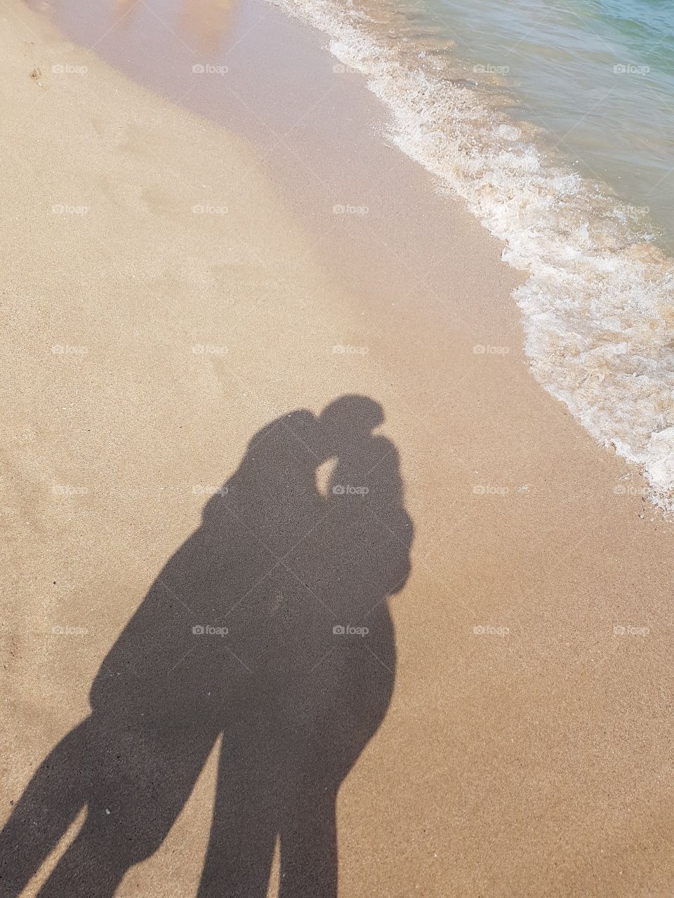 lovers on the beach shadows