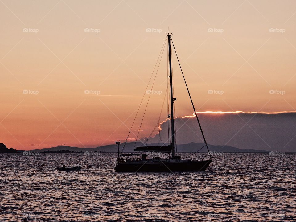 Sunset Behind A Sailboat On The Seas By Greece 