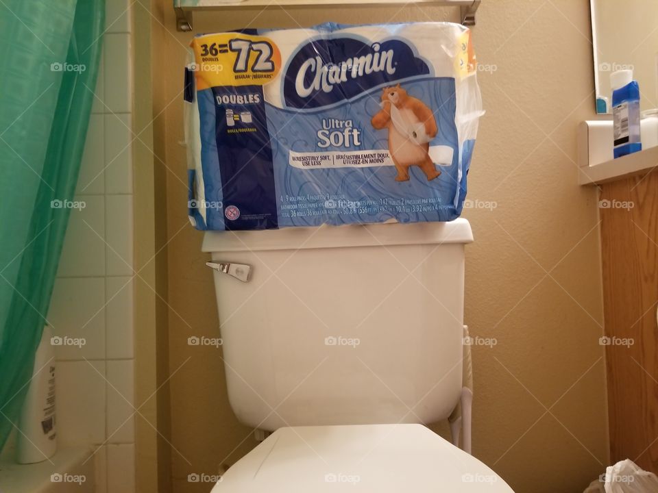 Toilet paper on top of toilet