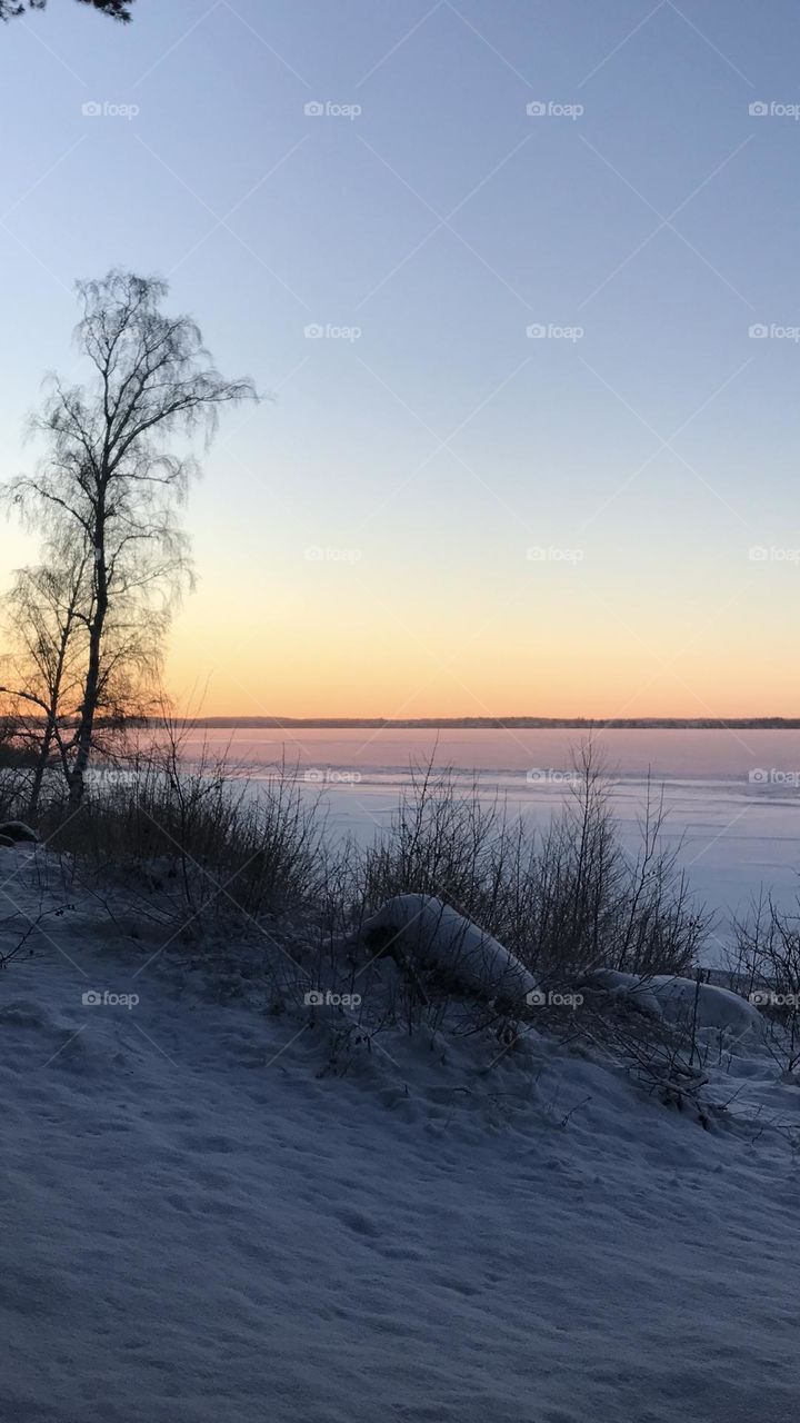 Sunset over frozen water