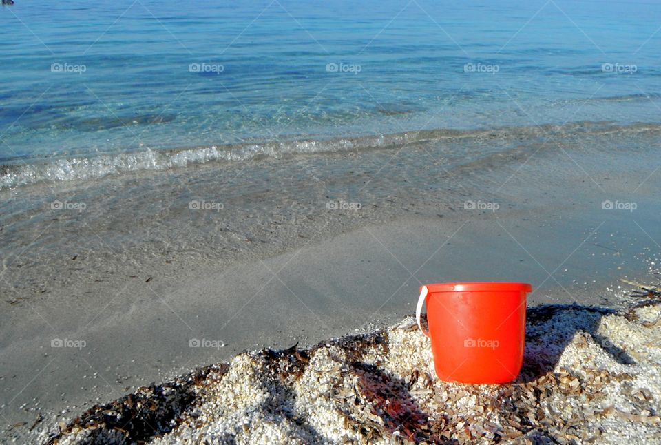 orange story in front of the blue sea