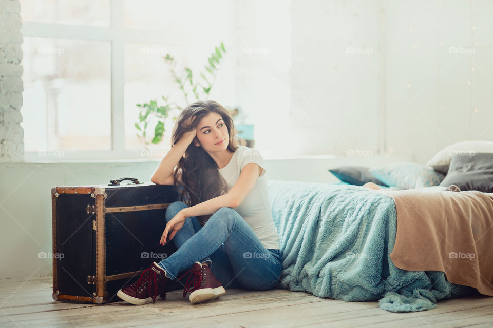 Beautiful young woman at home in daylight 