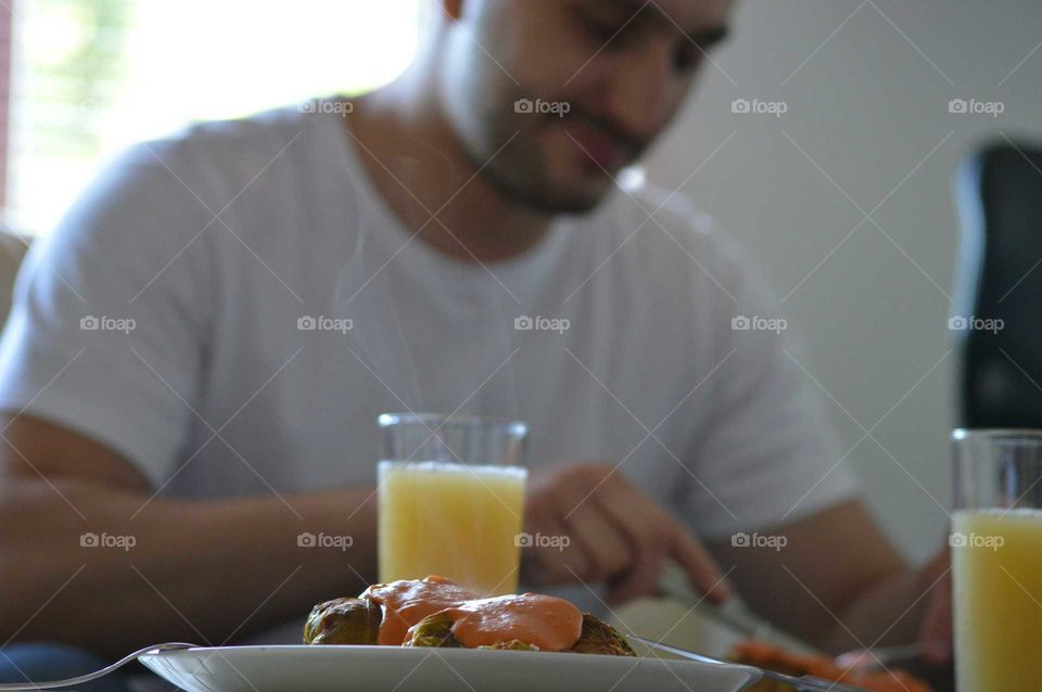 Man eats dinner 'Golabki' with tomato sauce - Polish flavors