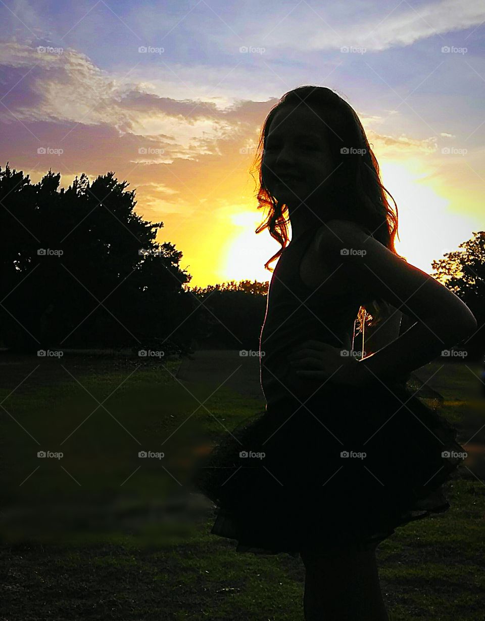 Molly, a happy & glowing 7 year old, stands proudly during 'Golden Hour' to declare her upcoming dawning of the age of 8. Hands and tutu, both on her hips; curls and pride, both cascading her shoulders.