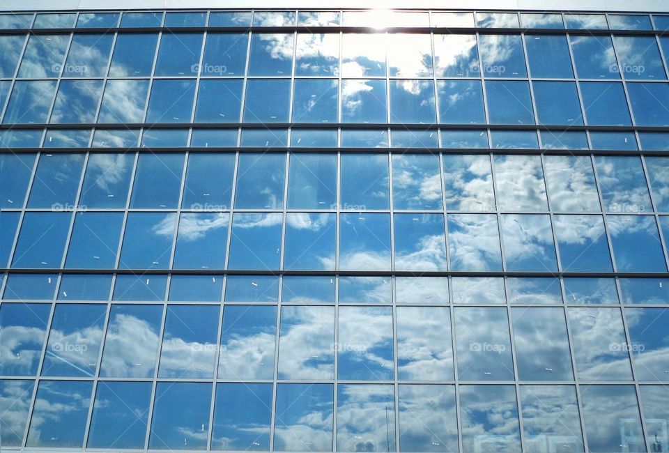 sky reflection with clouds in a glass building