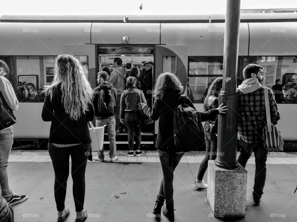 The world in black and white.. People waiting for the train.. People getting on the train