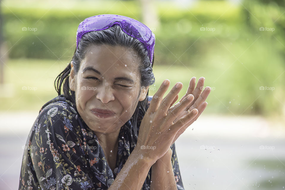 Asian woman play water in Songkran festival or Thai new year in Thailand.