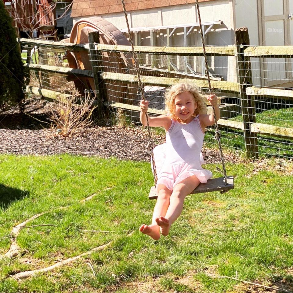 Childhood summer fun from a tree swing