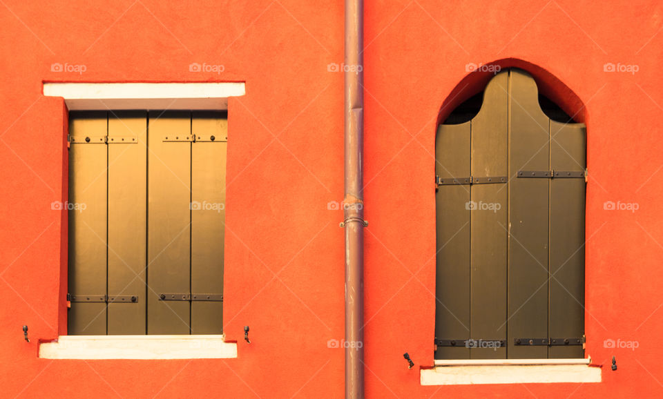 Windows And Shutters On Orange Wall In Venice, Italy
