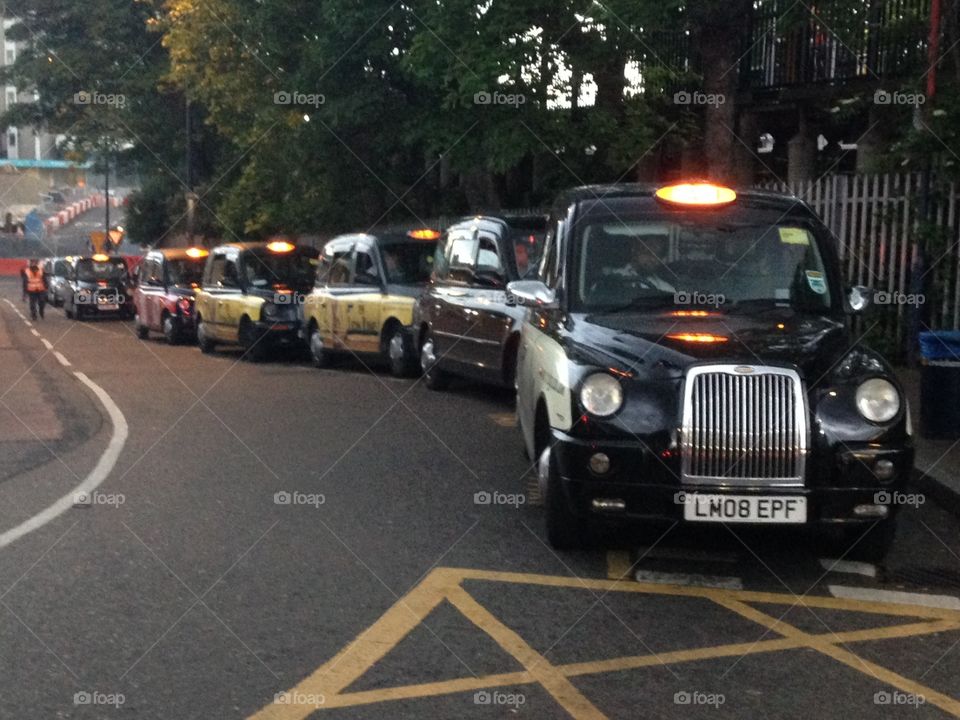 Row of empty black London cabs taxi 