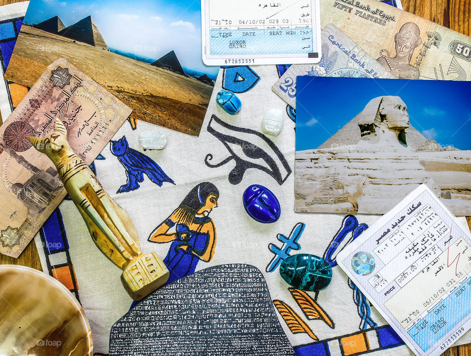 Egypt themed flat lay, featuring photos of the pyramids and Sphinx, hieroglyphs, tickets and currency