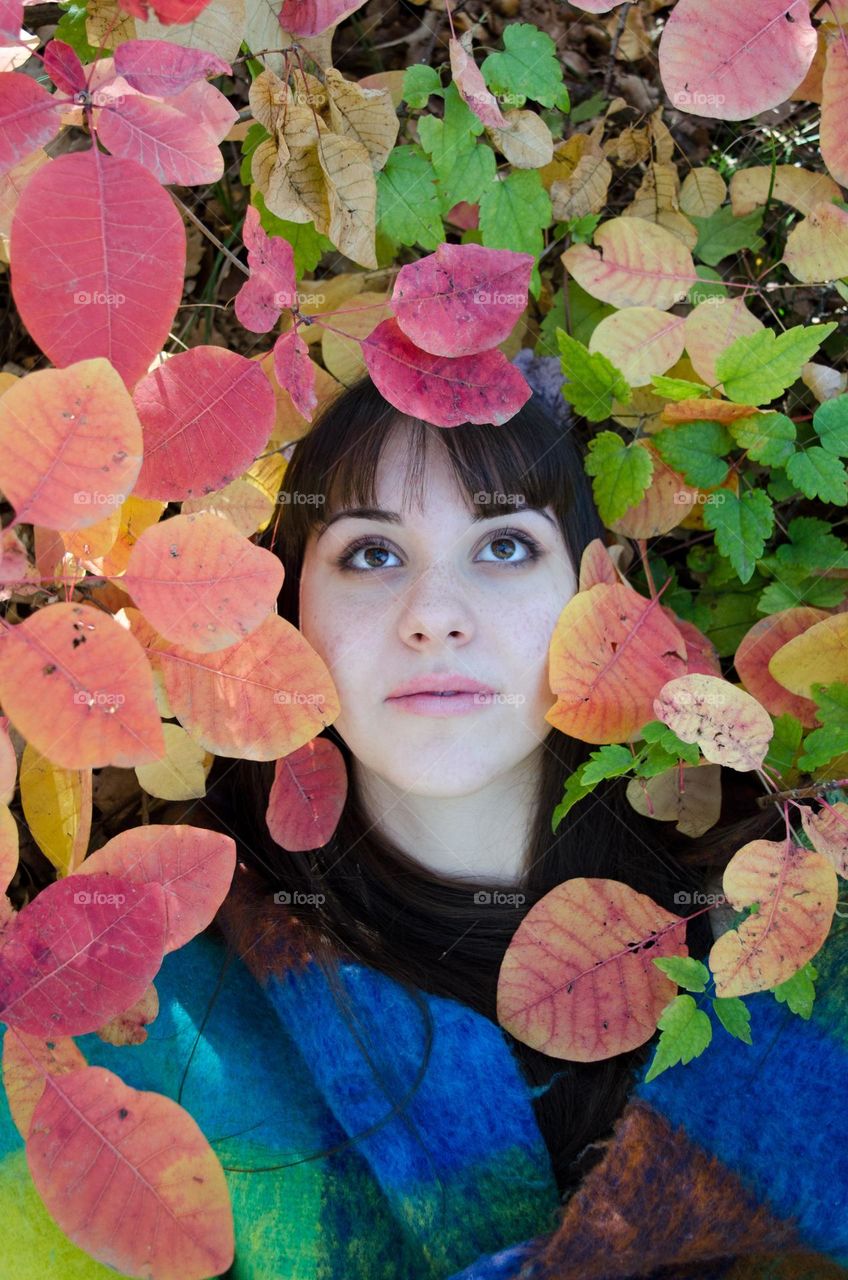 Portrait of a Beautiful Young Girl on Autumn Background