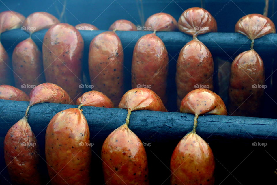 Smoked homemade sausage on the blavk background