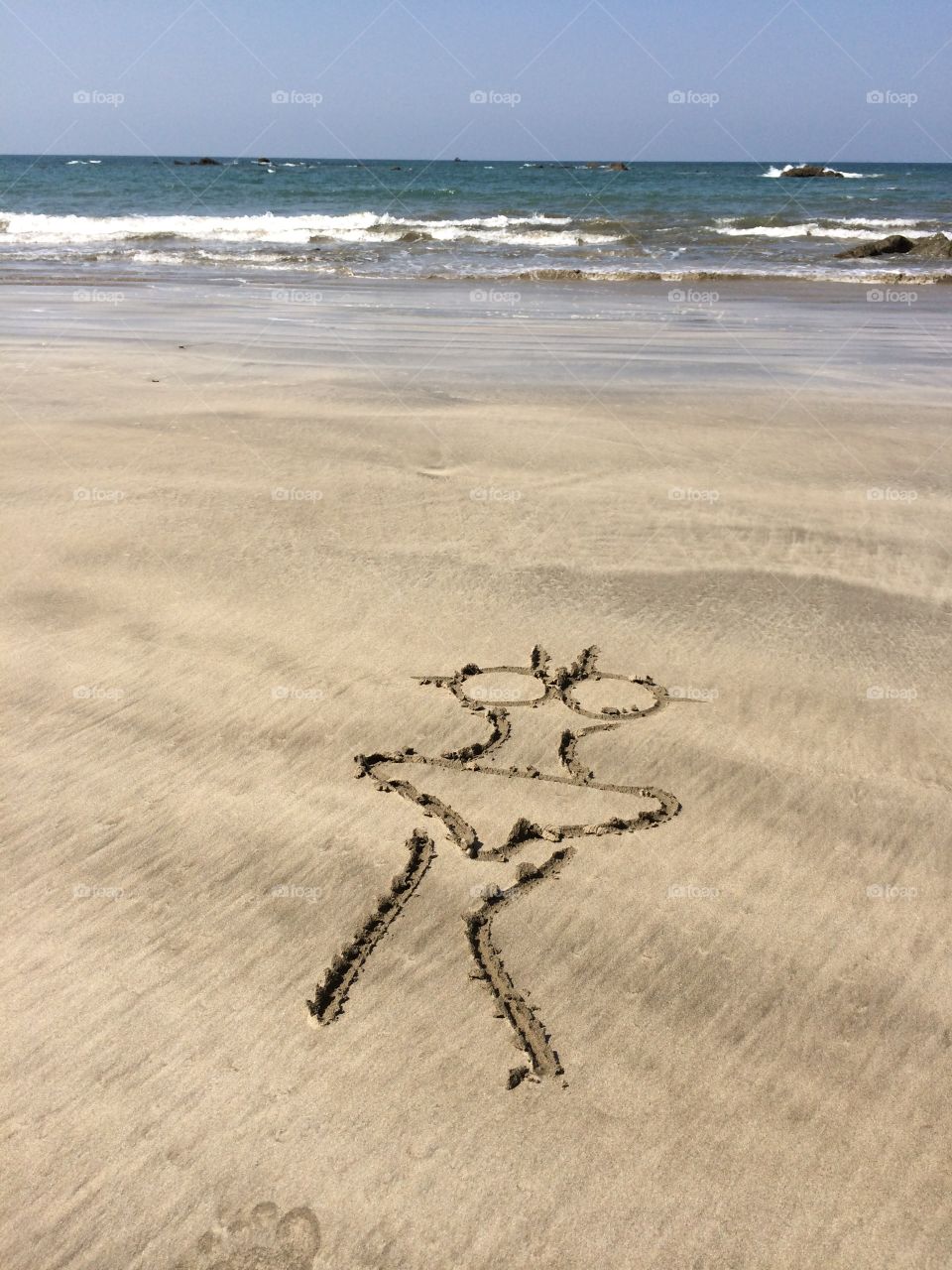 Drawing bikini on the beach