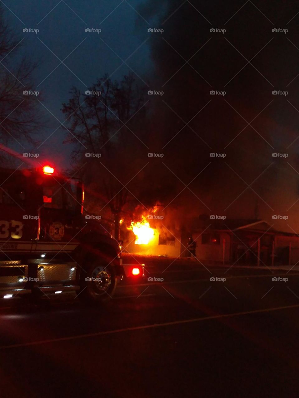 Firefighter entering burning structure