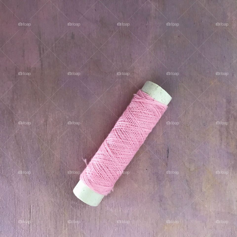 Close-up of pink thread reel