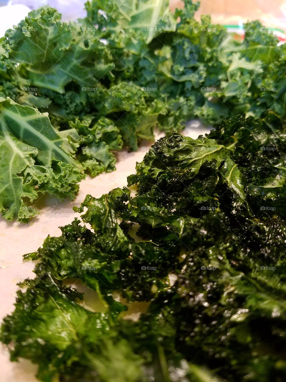 fresh raw kale alongside baked kale crispy chips, health food.