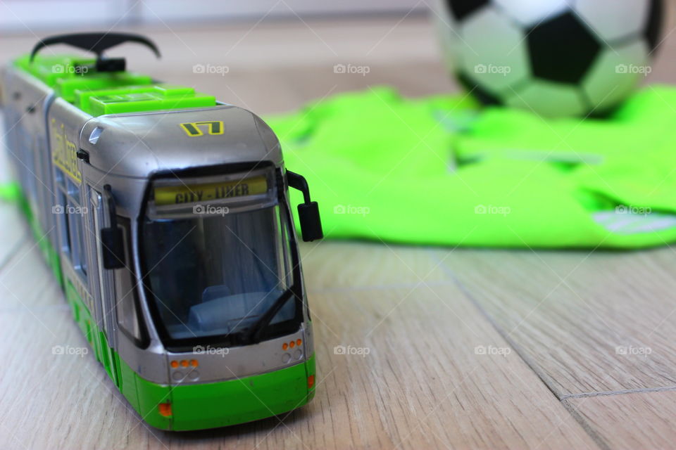 Toy train with basket ball lying on wooden floor