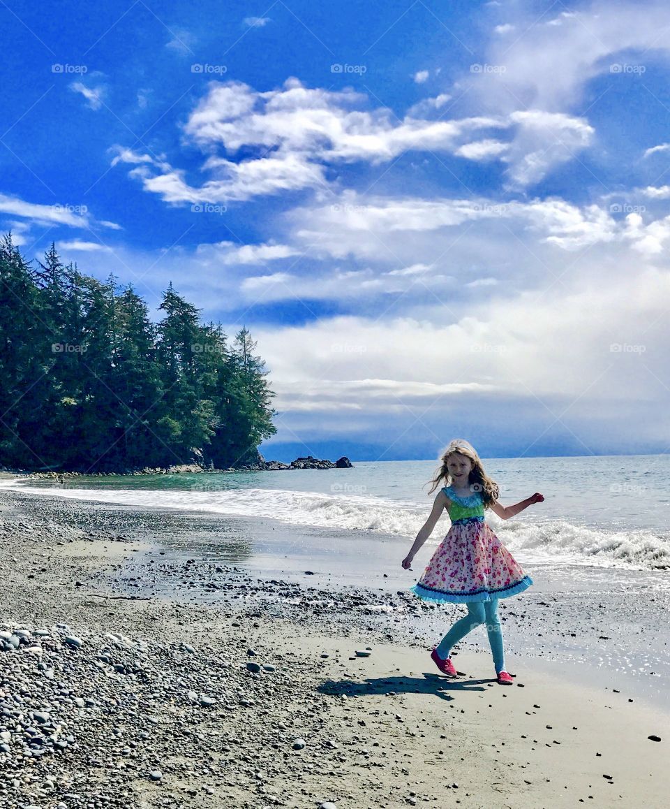 Dressed-up girl on beautiful ocean  setting 