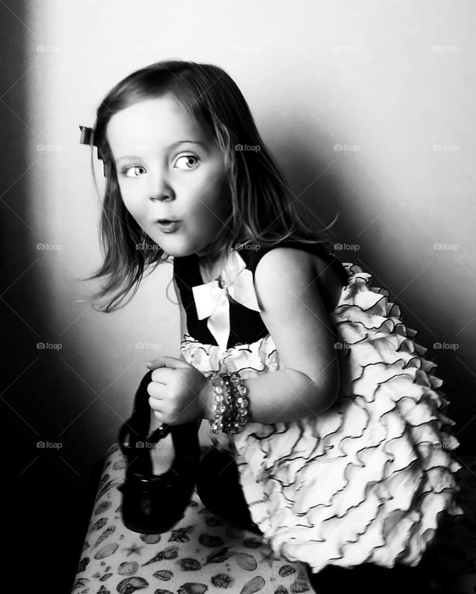 Black and white portrait of girl who appears mischievous