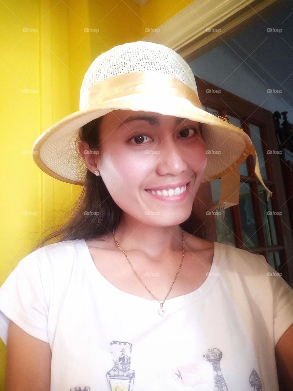 Smiling woman wearing a yellow hat