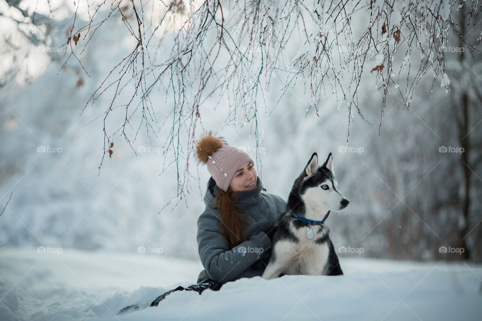 Walking with husky in winter park