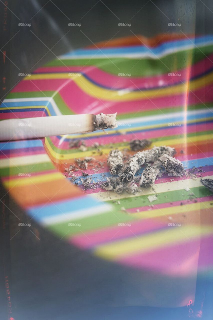 Cigarette in a colorful ashtray