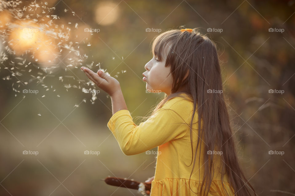 Little girl in yellow dress outdoor portrait 