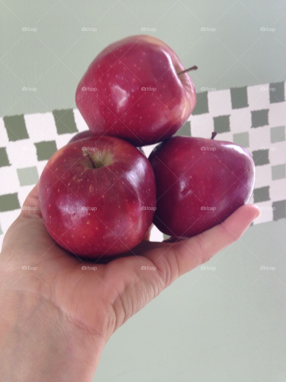 Holding red delicious apples 